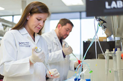 Graduate School of Biomedical Sciences showing students engaging in research studies