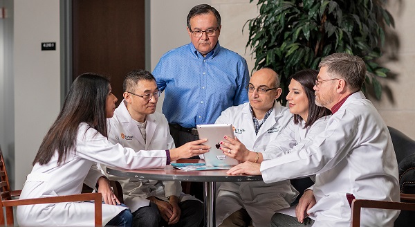 Group of researchers sitting around table