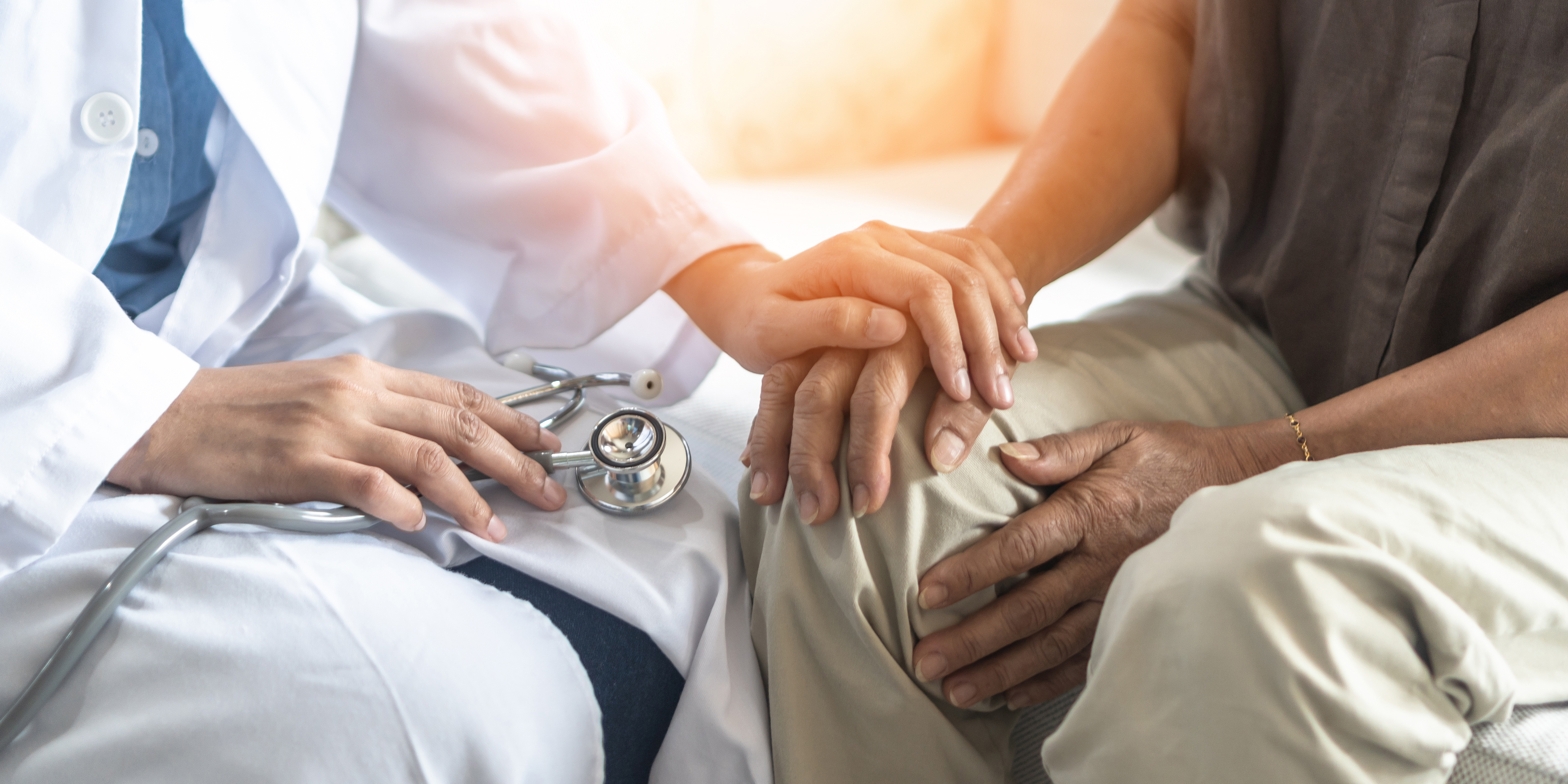 Doctor holding hand of patient