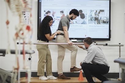 School of Health Professions instructing students in simulated patient care on physical therapy treatments