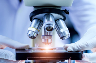 Scientist examining microscope close up photo examining slide